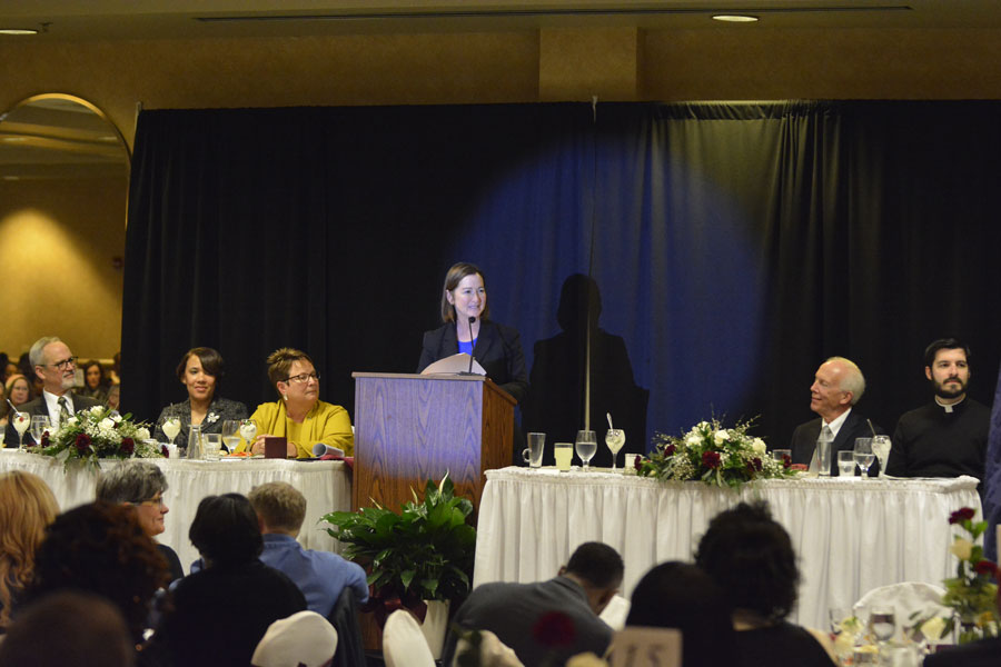  At podium: Keynote speaker Barbara L. McQuade, former United States Attorney for the Eastern District of Michigan. From far left: Rev. John Hice; Crossroads District Superintendent/United Methodist Church; Mayor Karen Weaver of the City of Flint; Dr. Susan E. Borrego, Chancellor, UM-Flint; Donald Rockwell, President , Michigan State Bar Association; Fr. James Mangan, St. Matthews Catholic Church