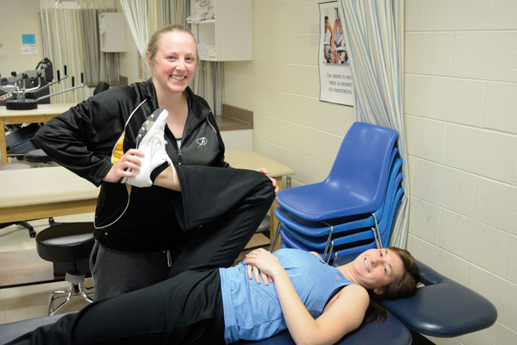 PTA student praticing stretching technique with second student