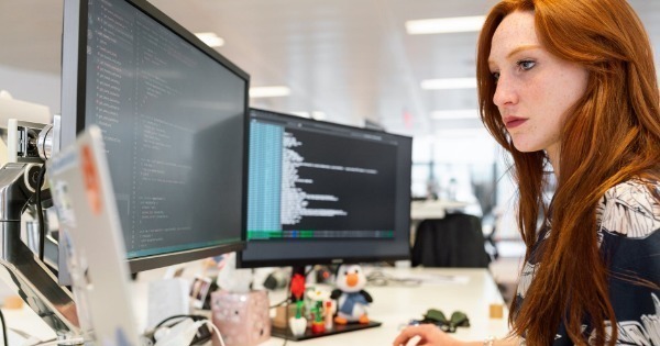 women at multiscreen computer