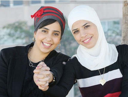 two students with hands clasped together