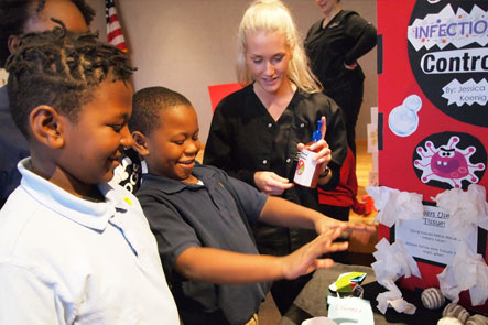 Student demonstrating dental hygiene to young children